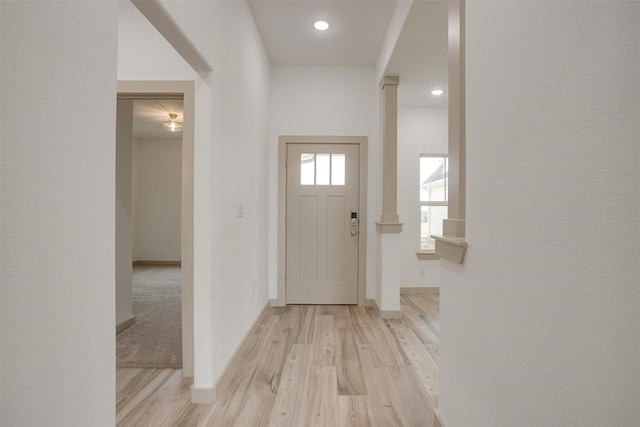 foyer entrance featuring light wood-style floors and baseboards