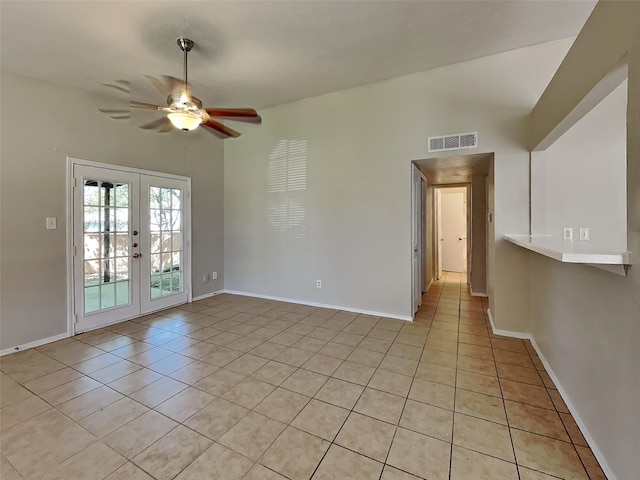 spare room featuring light tile patterned floors, baseboards, visible vents, ceiling fan, and french doors