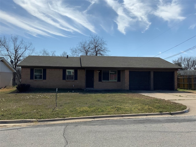 single story home featuring concrete driveway, roof with shingles, an attached garage, a front yard, and brick siding