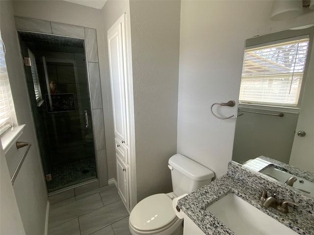 full bathroom with a closet, toilet, a stall shower, vanity, and tile patterned flooring