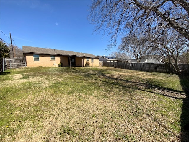 view of yard with a fenced backyard