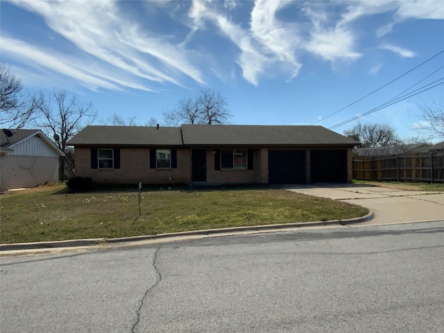 view of front of house with a garage, concrete driveway, and a front lawn