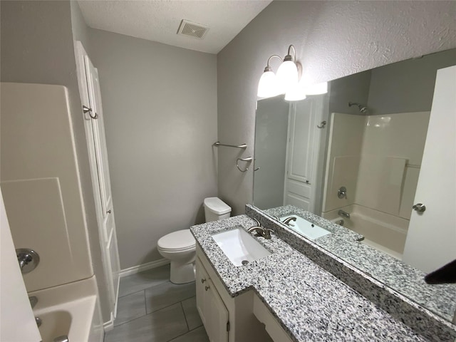 bathroom with a textured ceiling, shower / bath combination, vanity, and visible vents