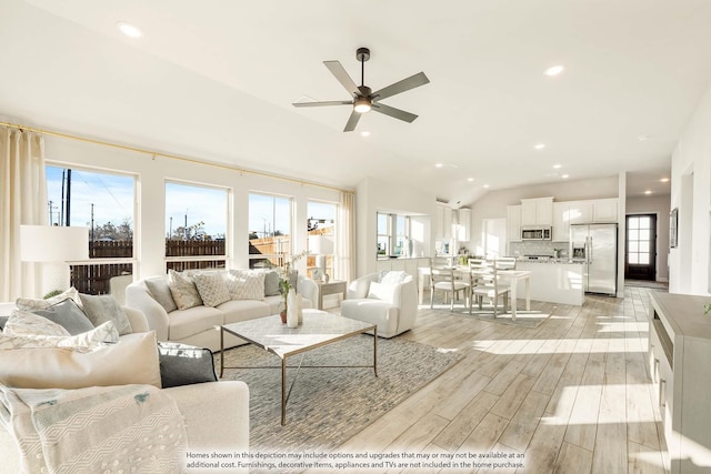 living area featuring light wood-style floors, recessed lighting, ceiling fan, and lofted ceiling