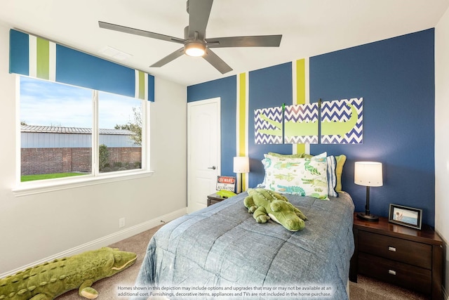 bedroom with a ceiling fan, baseboards, and carpet flooring