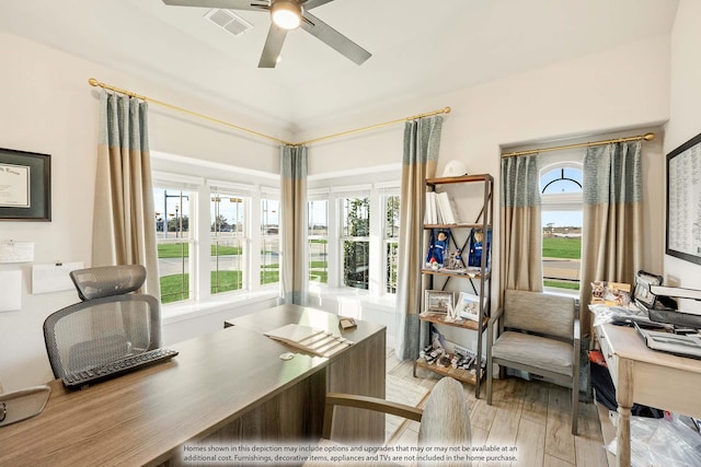 home office with ceiling fan, light wood-style flooring, and a healthy amount of sunlight