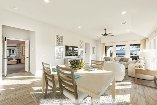 dining space featuring recessed lighting, visible vents, ceiling fan, vaulted ceiling, and light wood-type flooring