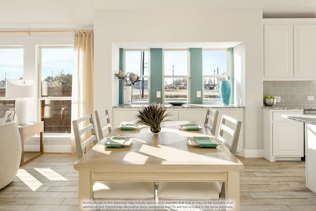 dining space with wood finish floors and a wealth of natural light