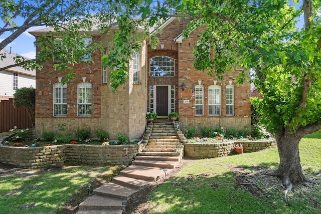 view of front of property featuring brick siding and a front lawn