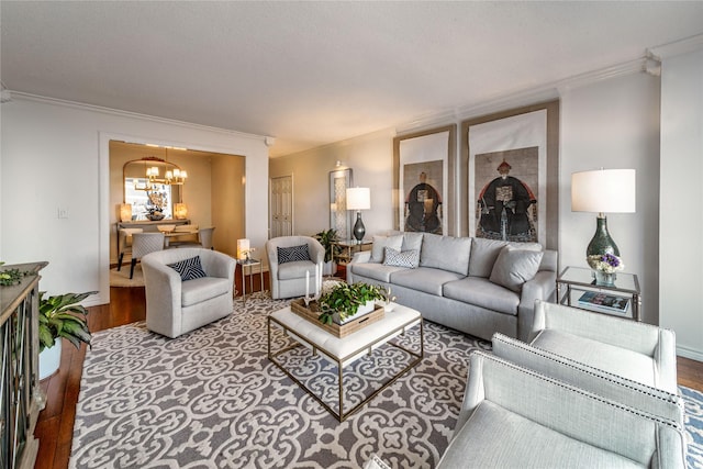 living area featuring wood finished floors, a chandelier, and ornamental molding