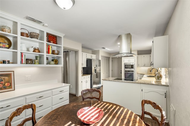 kitchen with island range hood, a sink, white cabinetry, appliances with stainless steel finishes, and open shelves