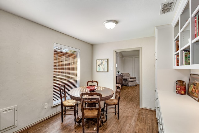 dining area featuring wood finished floors and visible vents