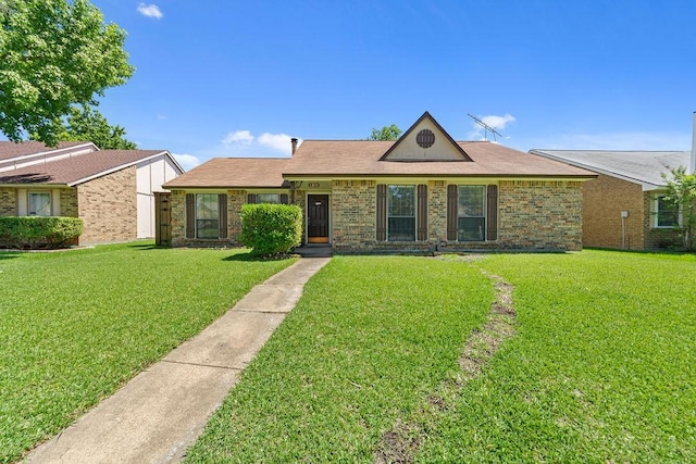 ranch-style house with a front lawn and brick siding