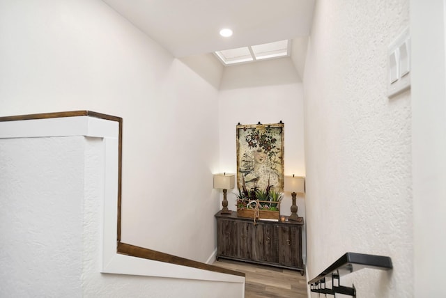 hallway with a textured wall and light wood-style flooring