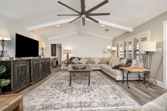 living room with a ceiling fan, visible vents, vaulted ceiling with beams, and wood finished floors