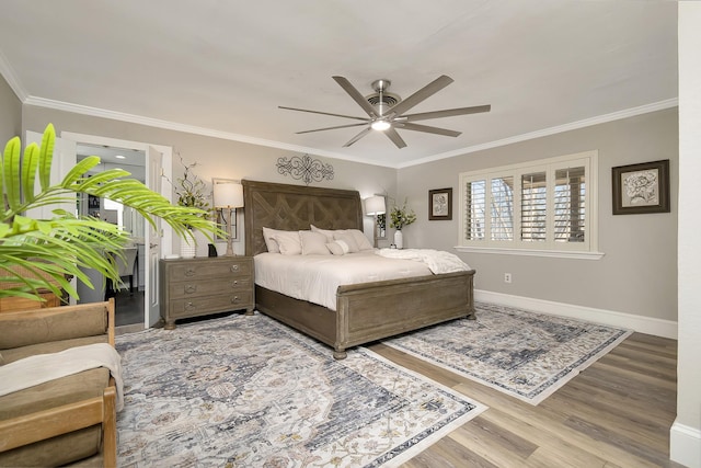 bedroom featuring a ceiling fan, baseboards, ornamental molding, and wood finished floors