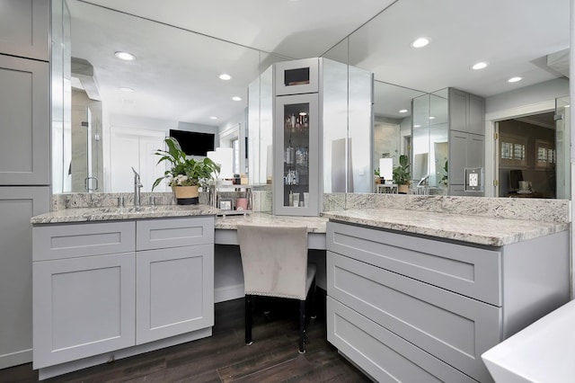 bathroom with recessed lighting, vanity, and wood finished floors