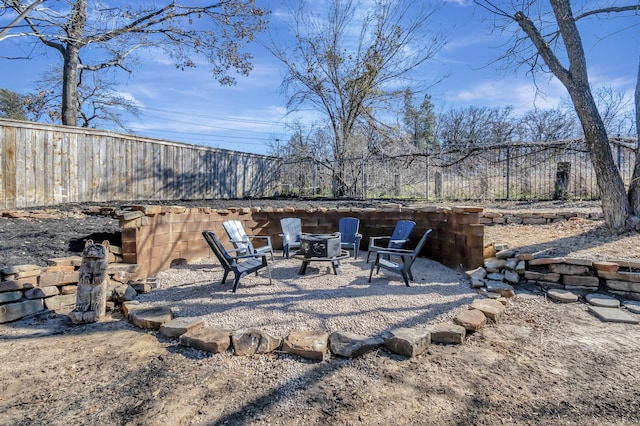 view of patio with a fire pit and fence