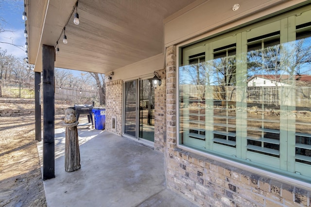 view of patio / terrace featuring area for grilling and fence