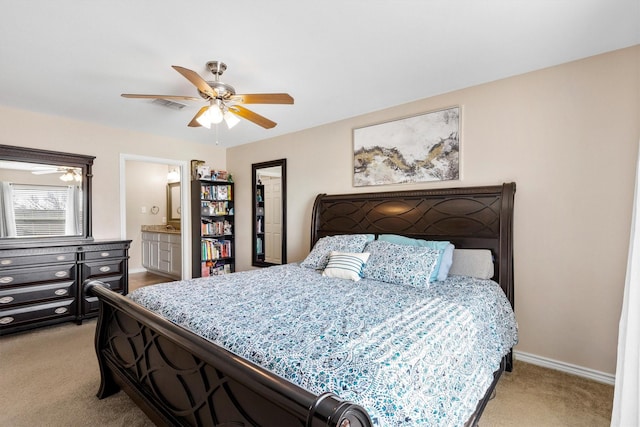 bedroom with ensuite bathroom, light colored carpet, a ceiling fan, baseboards, and visible vents