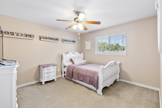 bedroom featuring baseboards, a ceiling fan, and light colored carpet