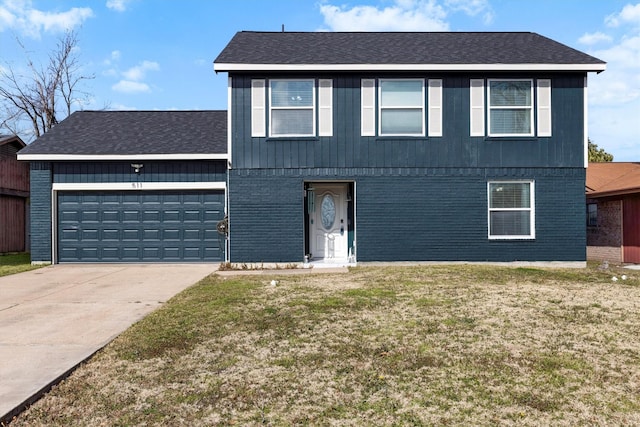 view of front of home featuring a garage, driveway, a front yard, and brick siding