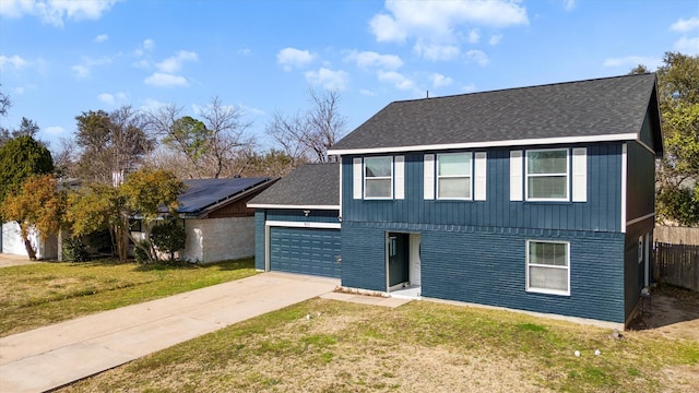 view of front of home with a garage, driveway, a shingled roof, a front yard, and brick siding