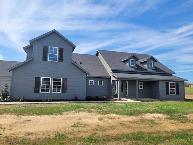 view of front of house featuring roof with shingles