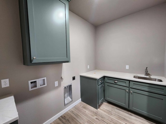 laundry area featuring washer hookup, cabinet space, hookup for an electric dryer, a sink, and light wood-type flooring