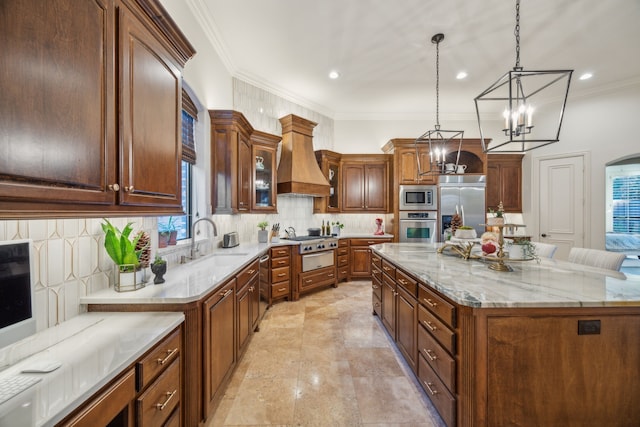 kitchen featuring decorative light fixtures, a large island, custom exhaust hood, a sink, and built in appliances