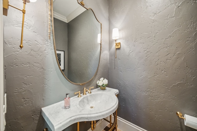 bathroom featuring vanity, crown molding, and a textured wall