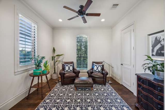 living area featuring ornamental molding, a healthy amount of sunlight, and visible vents