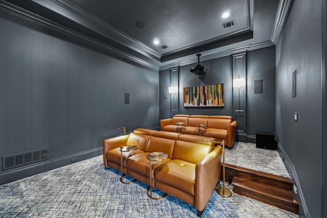 cinema featuring visible vents, a tray ceiling, and ornamental molding