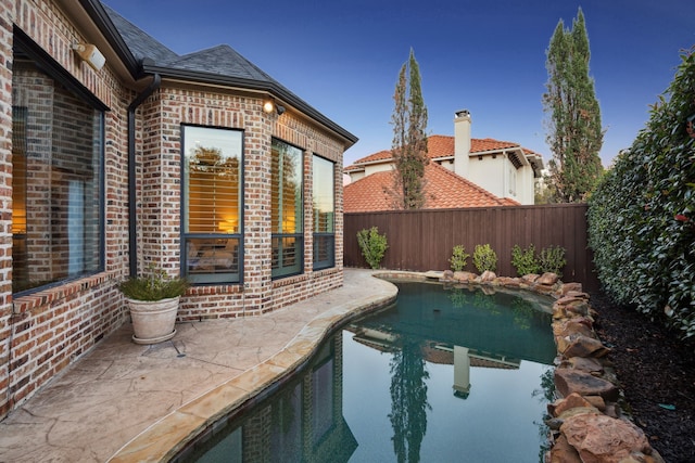 view of pool with a patio area, a fenced backyard, and a fenced in pool