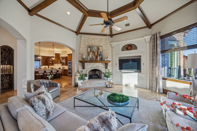 living room with a high ceiling, visible vents, beam ceiling, and a stone fireplace