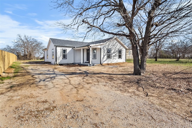 view of front of home with fence and driveway