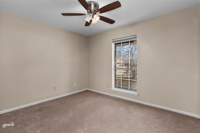 spare room featuring carpet, a ceiling fan, and baseboards