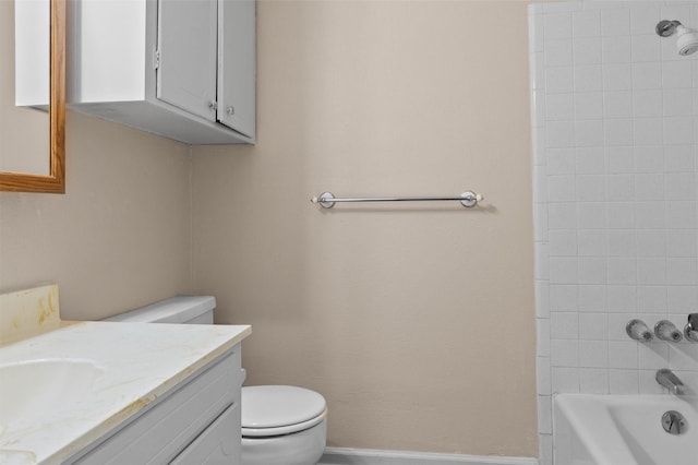 bathroom with baseboards, shower / bath combination, vanity, and toilet