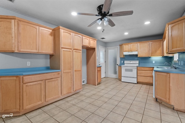 kitchen with white electric stove, light brown cabinets, under cabinet range hood, a sink, and light countertops