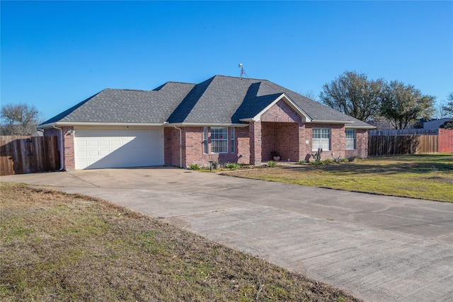 ranch-style house with an attached garage, roof with shingles, fence, and a front yard