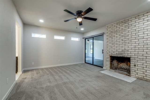 unfurnished living room with recessed lighting, light colored carpet, a brick fireplace, ceiling fan, and baseboards