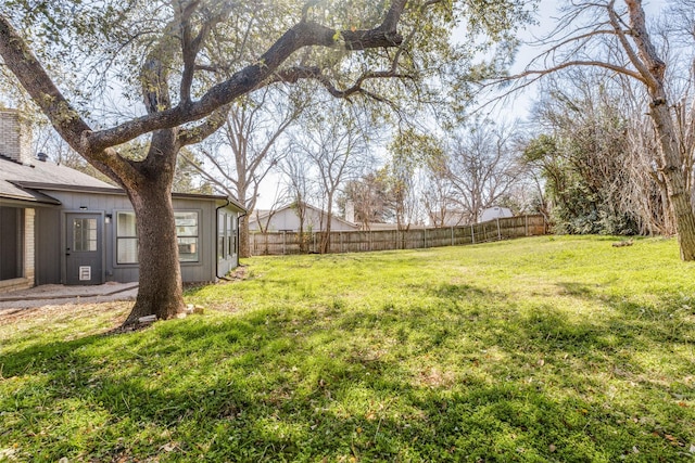 view of yard with a fenced backyard