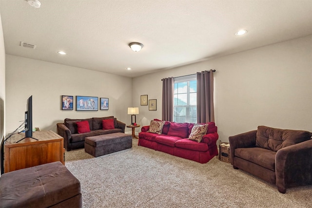 living area featuring light carpet, visible vents, and recessed lighting