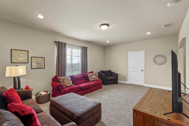 carpeted living area with recessed lighting, visible vents, a textured ceiling, and baseboards