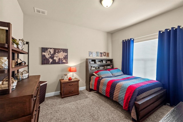 carpeted bedroom featuring visible vents and baseboards