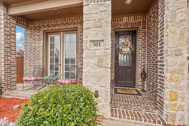 entrance to property featuring brick siding