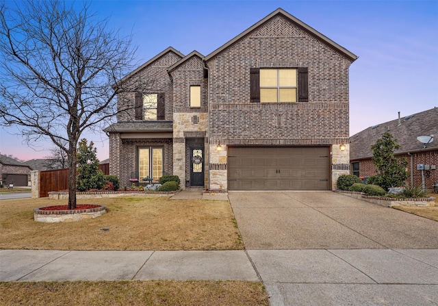 traditional home featuring a garage, a lawn, concrete driveway, and brick siding