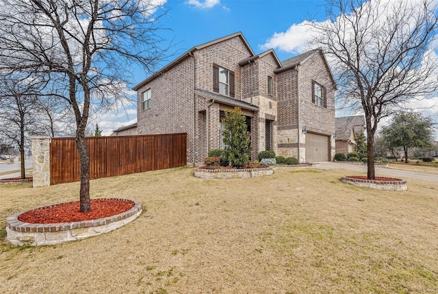 view of front of house with a front lawn, brick siding, fence, and an attached garage