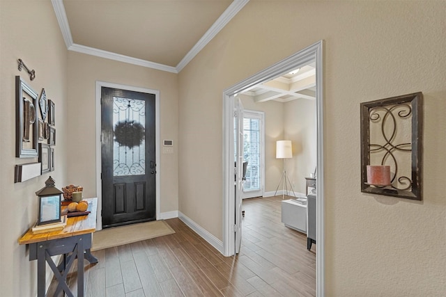 foyer entrance with coffered ceiling, wood finished floors, baseboards, beamed ceiling, and crown molding