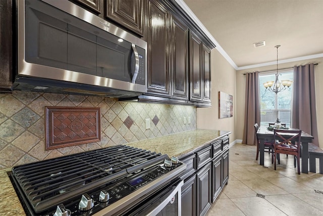 kitchen with ornamental molding, light stone counters, appliances with stainless steel finishes, and visible vents